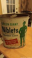 Green Giant Niblets whole kernel golden corn metal trash can featuring vintage design and character on cream background