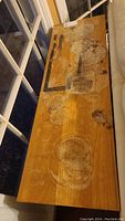 Top view of wooden sofa table showing multiple stains and marks on the surface including circular discolorations and dark spots.