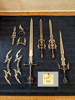 Overview of 12 fantasy decorative blades including swords, daggers, and throwing knives displayed on black fabric