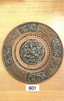 Front view showing detailed Ganesh figure at center with floral and ornamental panels around perimeter.