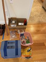Overview of all items including the boxed hardware, tool holder, tape measure, and other small components