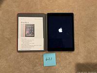 iPad Air 2 with opened cover showing device and printed info sheet