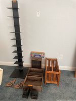 Photo showing the full assortment of organizers including the tall black metal tower organizer with multiple shelves, pair of metal shelf brackets, wooden trays, bookends, and wooden magazine holder.