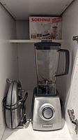 VillaWare blender with clear pitcher and silver base situated on shelf with Soehnle scale box behind
