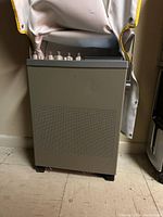 Side view of the oscilloscope showing control knobs and connectors on top.