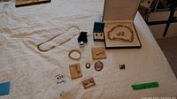 Overview photo of all jewelry pieces laid out including necklaces, earrings, brooches, and pin.