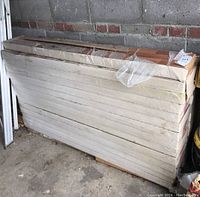 Stacked unopened boxes of laminate flooring in garage
