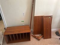 Record holder cabinet with dividers, rails, shelves and brackets arranged on floor