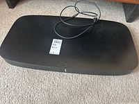 Top-down view of soundbase showing overall shape and attached power cable