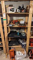 Wooden shelving unit containing various tools and accessories