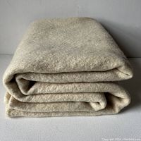 Folded wool blanket showing thickness and texture of the material.