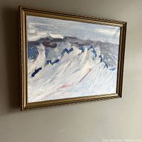 Angled view of framed abstract oil painting showing texture of brush strokes and composition.