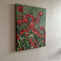 Angle view of the original acrylic painting on canvas showing red poppies in a field with visible texture and alpha effect of pointillism.