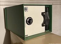 Green portable safe closed; cream door with black combination dial and handle
