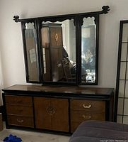 Low dresser with six drawers and trifold mirror attached, black lacquer frame with burled wood drawer fronts and brass hardware