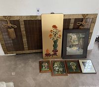 Overall lot view showing fireplace screen, lacquered Jadeite panel, watercolor in dark wood frame, and four Asian prints.