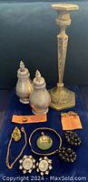 Group shot of candlestick, salt and pepper shakers, dental gold, cufflink parts and assortment of jewelry