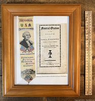 Framed silk bookmark and Funeral Oration photocopy with wooden ruler for size reference.