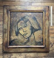 Front view of framed painting on wooden floor with ruler alongside