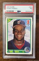 Front side of 1990 Score Frank Thomas rookie card graded PSA 7 Near Mint condition.