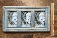 Front view of the rectangular triple Buddha picture frame showing three identical Buddha face images, painted distressed blue wooden frame.