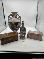 Shows front full view of all four items: floral dragon vase, terracotta warrior figurine, carved wooden box, and decorative box.