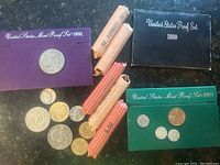 Overview of proof sets in original folders, loose coins and pennie rolls.