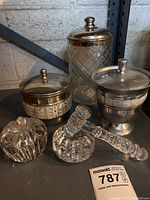 Overview of all five items including crystal glass apple, pestle and mortar, and three metal/glass canisters