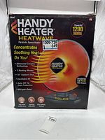 Box front view showing Handy Heater Heatwave parabolic space heater, 1200 watts, features and branding.