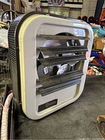 Front view showing metal louvers and Qmark logo