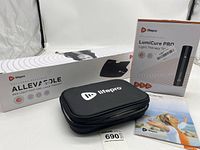 Photo of boxed Alleva Sole and LumiCure Pro Light Therapy Torch with LifePro branded black carrying case and pamphlets.
