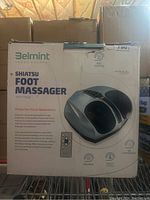 Box front showing the Belmint Shiatsu Foot Massager branding, image of the device, and features including heat and air compression.
