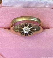 Engagement and wedding bands stacked inside pink velvet ring box