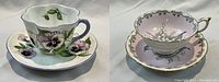 Both Shelley and Paragon teacup and saucer sets side by side