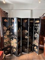 Full view of seven-panel folding screen in black lacquer with bird and flower motifs