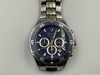 Front view showing blue dial, subdials, and date window