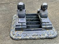 Top-front view showing two sphinx figures and scraping bars