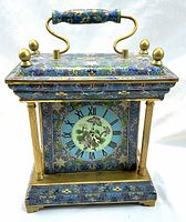 Front view of cloisonné enamel clock showing case, dial and brass accents