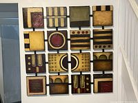 Full front view of assembled 16-panel artwork showing all panels and steel frame