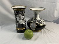Two vases side by side with green apple for scale