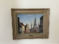 Frontal view of entire painting in carved wood frame on wall