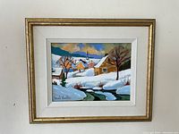 Full view of framed oil painting depicting a snow-covered village scene with pastel houses and church steeple