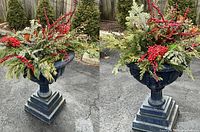 Cast iron urn filled with evergreen branches and red berries on driveway