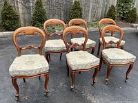 Front and angled front view of all six chairs on pavement background