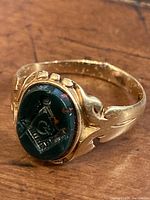 Front angle showing oval bloodstone bezel carved with Masonic compass and square