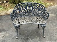 Front view of ornate cast iron garden bench