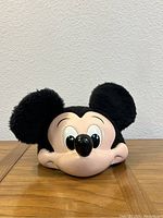 Front view of the vintage Disney Mickey Mouse hat showing the molded plastic face and plush ears.