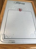 Front view of vintage Tanqueray bar mirror showing the wooden frame, Tanqueray script and decorative etched panel