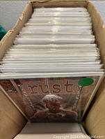 Box of bagged comic books with 'Rust' at front
