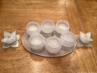 Full set of carved stone stemware with platter and candlesticks arranged on a table, showing unique natural stone patterns.